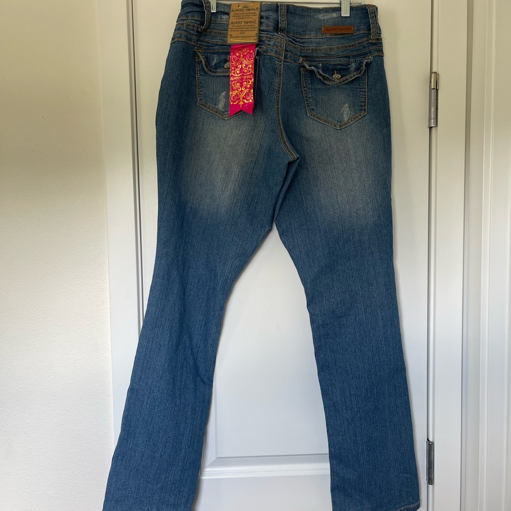Y2K Blue distressed boot cut jeans with a medium wash and mid rise